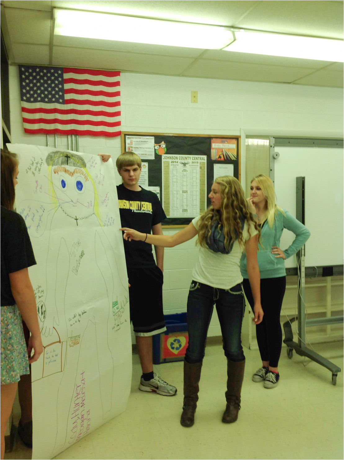 Senior, Melissa Bausch, explains key characteristics of the characterization poster created by members of her group.