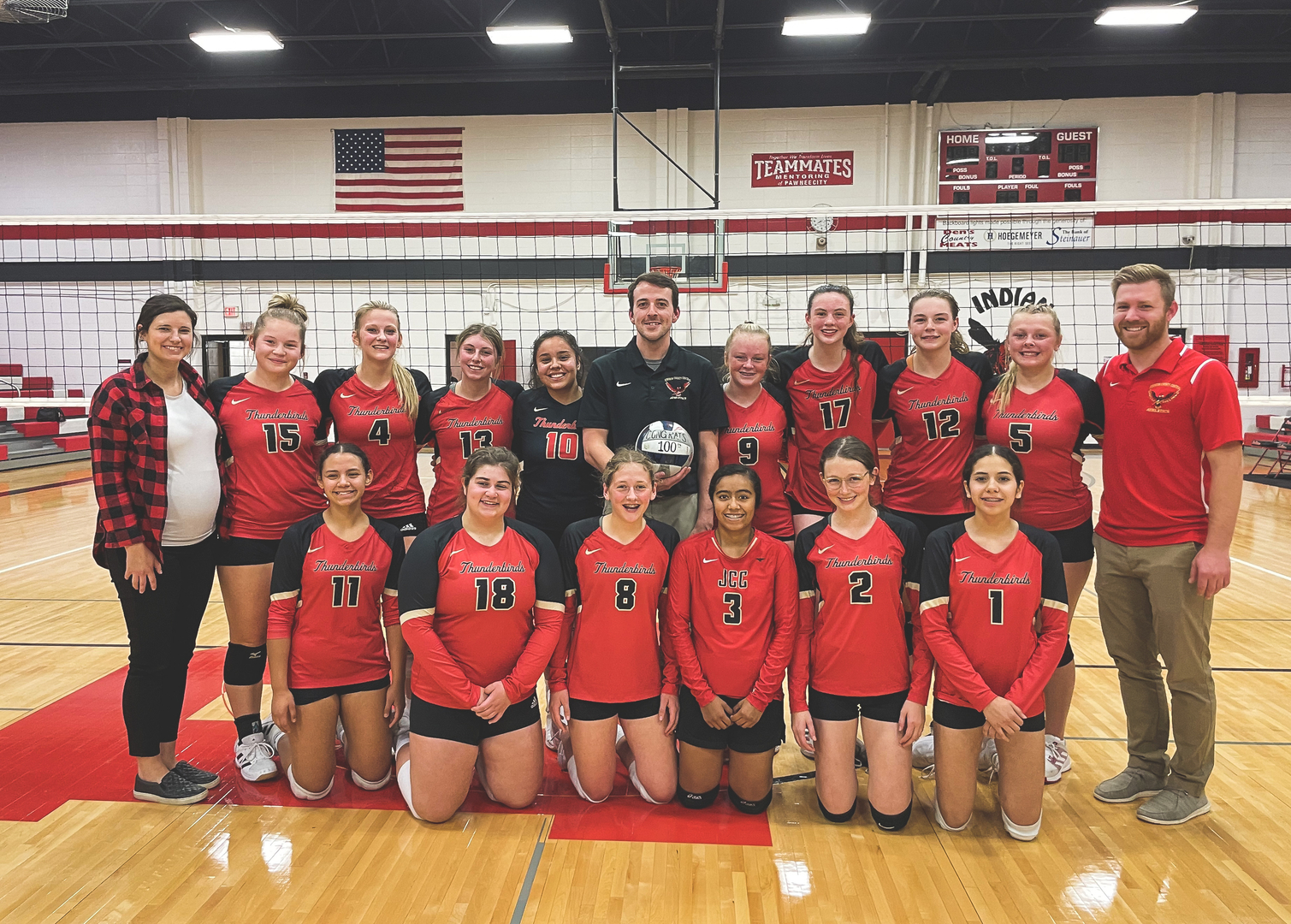 JCC Volleyball present Coach Hedger with a signed volleyball for his 100th win