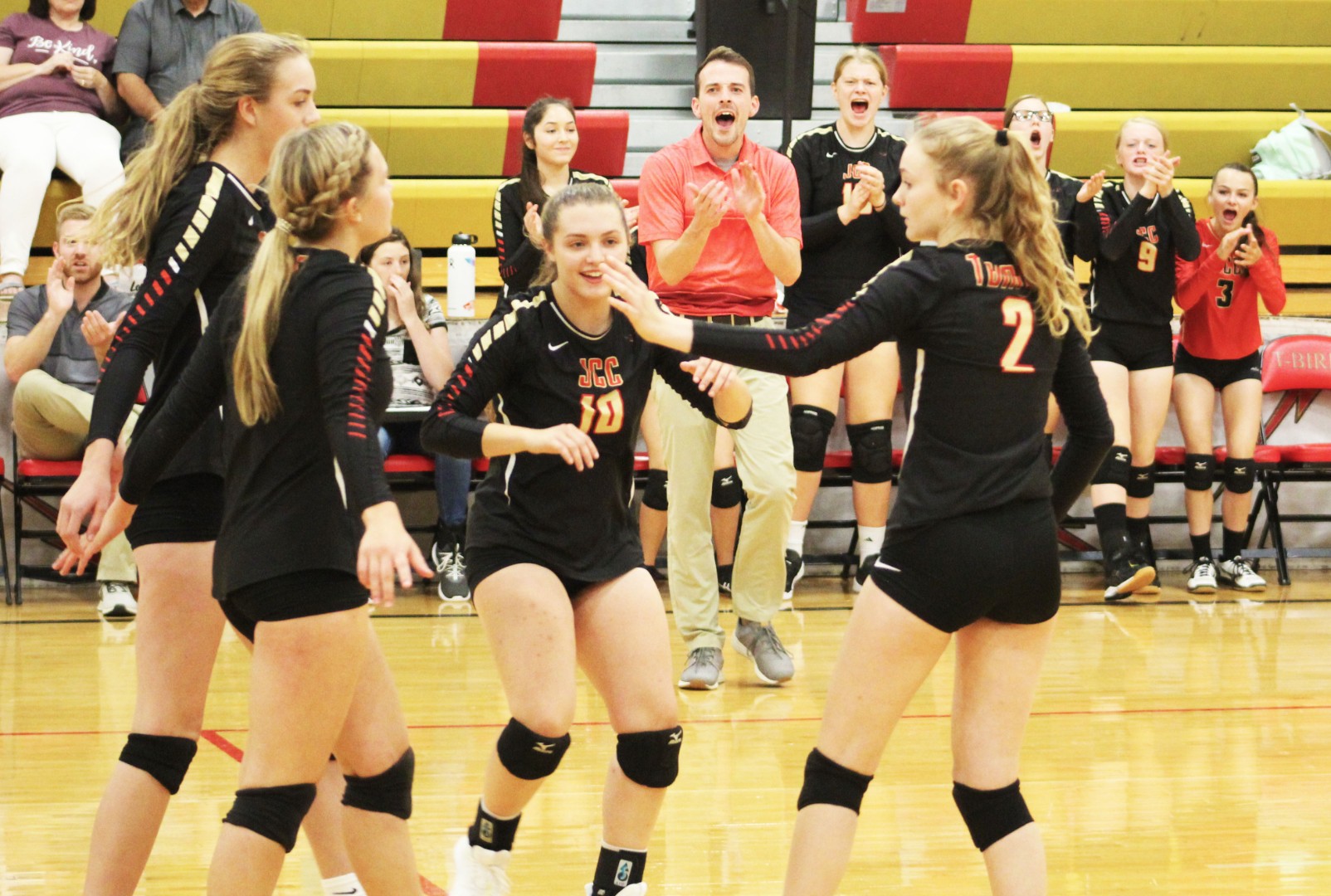 JCC Volleyball players with player bench in background - 2019