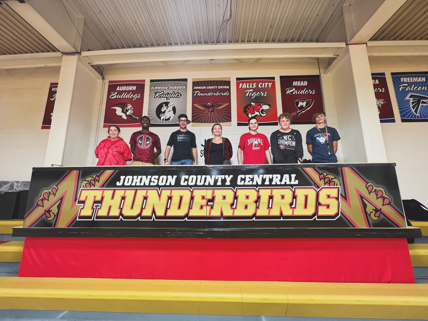 JCC Striv Crew standing on the streaming platform in the high school gym