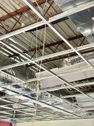 Ductwork above a ceiling grid.
